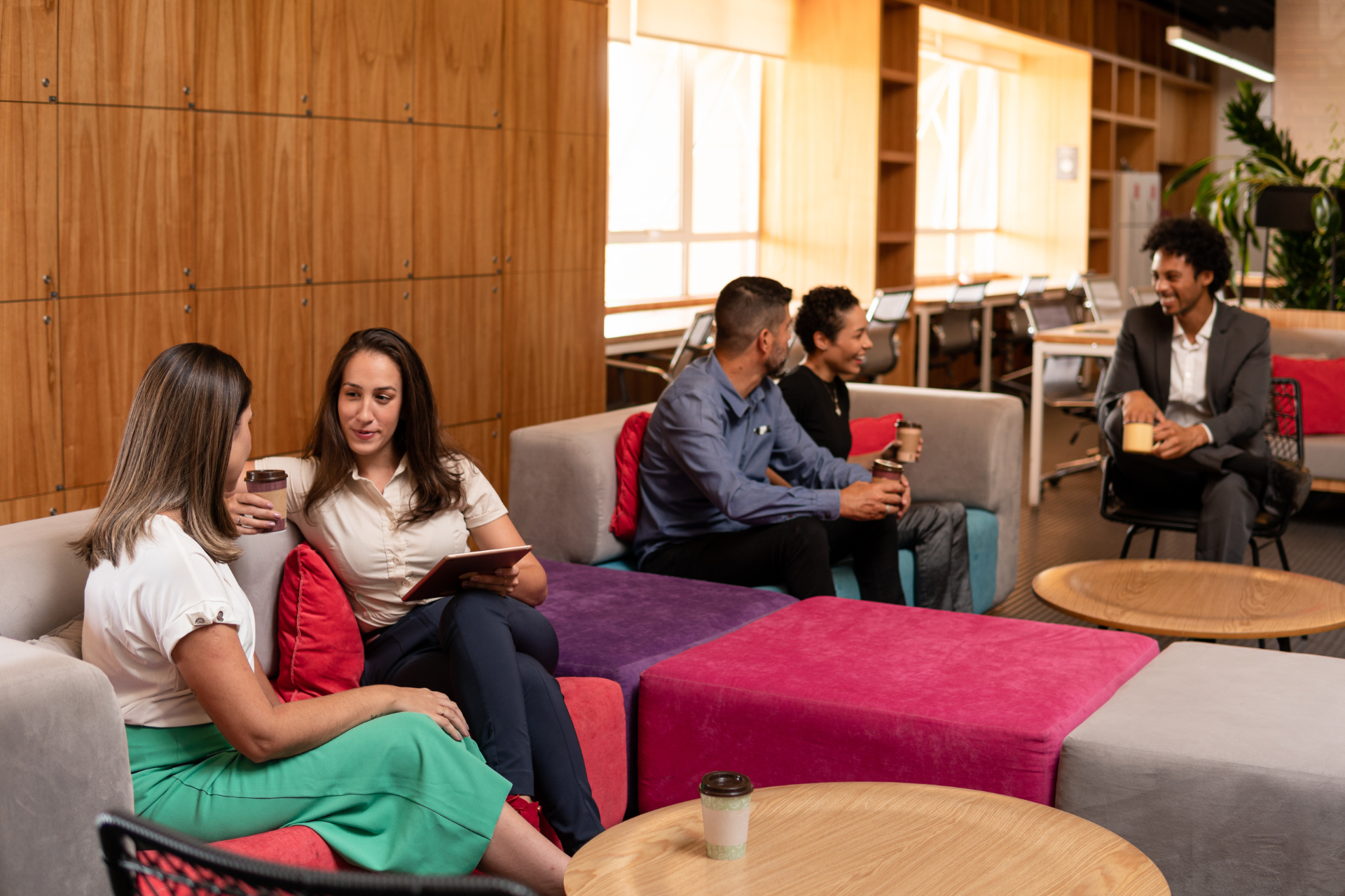 diverse business workgroup talking causally with co workers.on office sofa