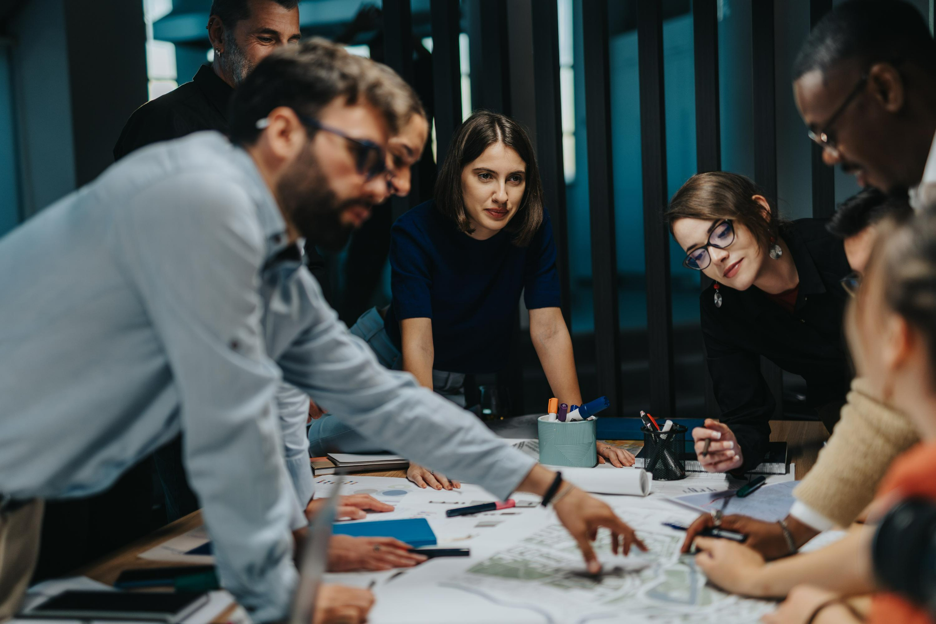 A diverse group of multigenerational business people collaborates on a project
