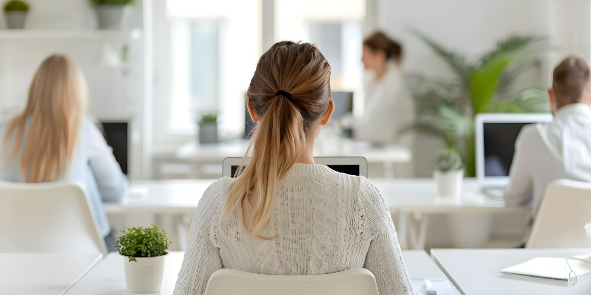 Diverse group working at desks in a bright room each focused