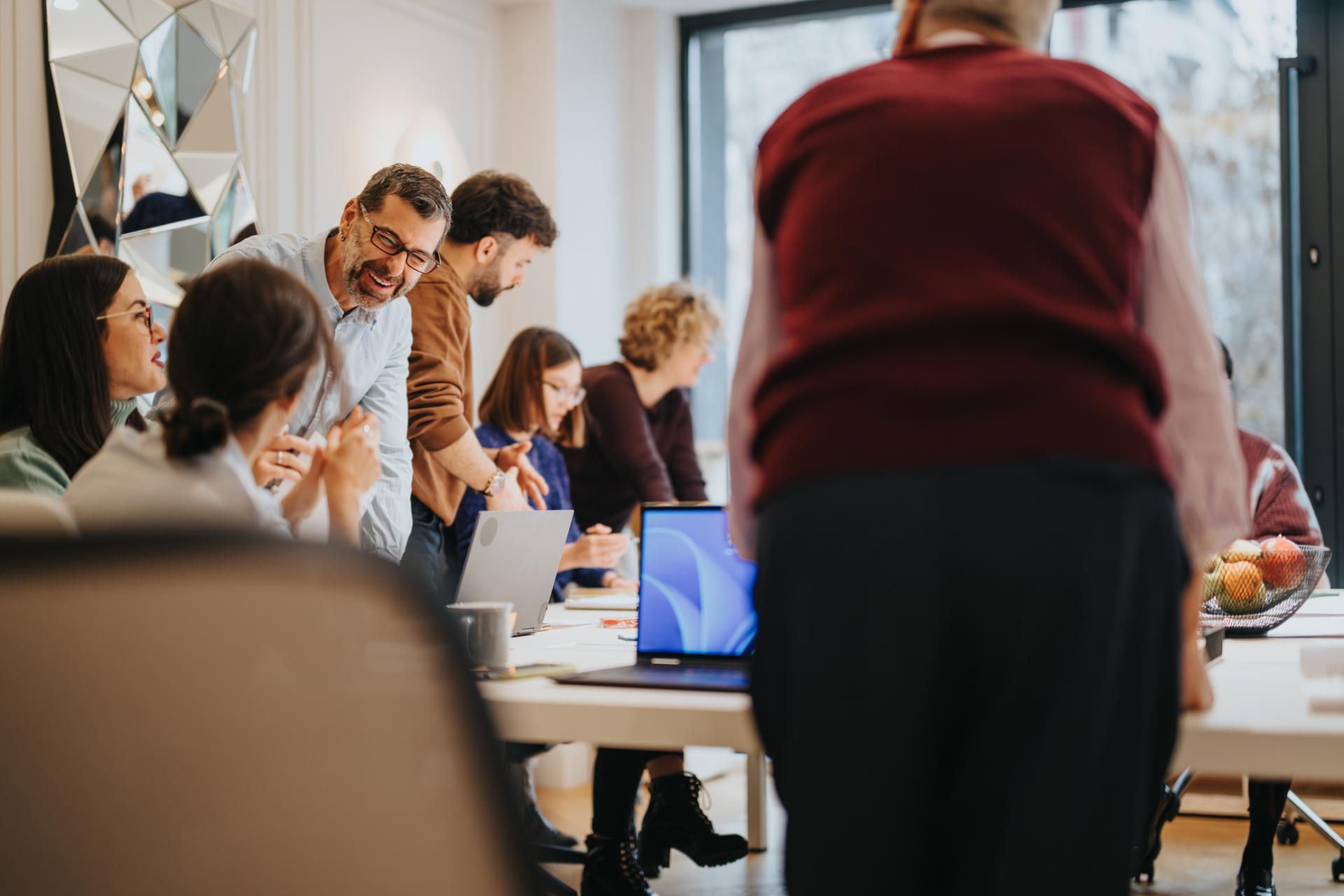 Engaged coworkers in a dynamic office environment sharing ideas and laughter