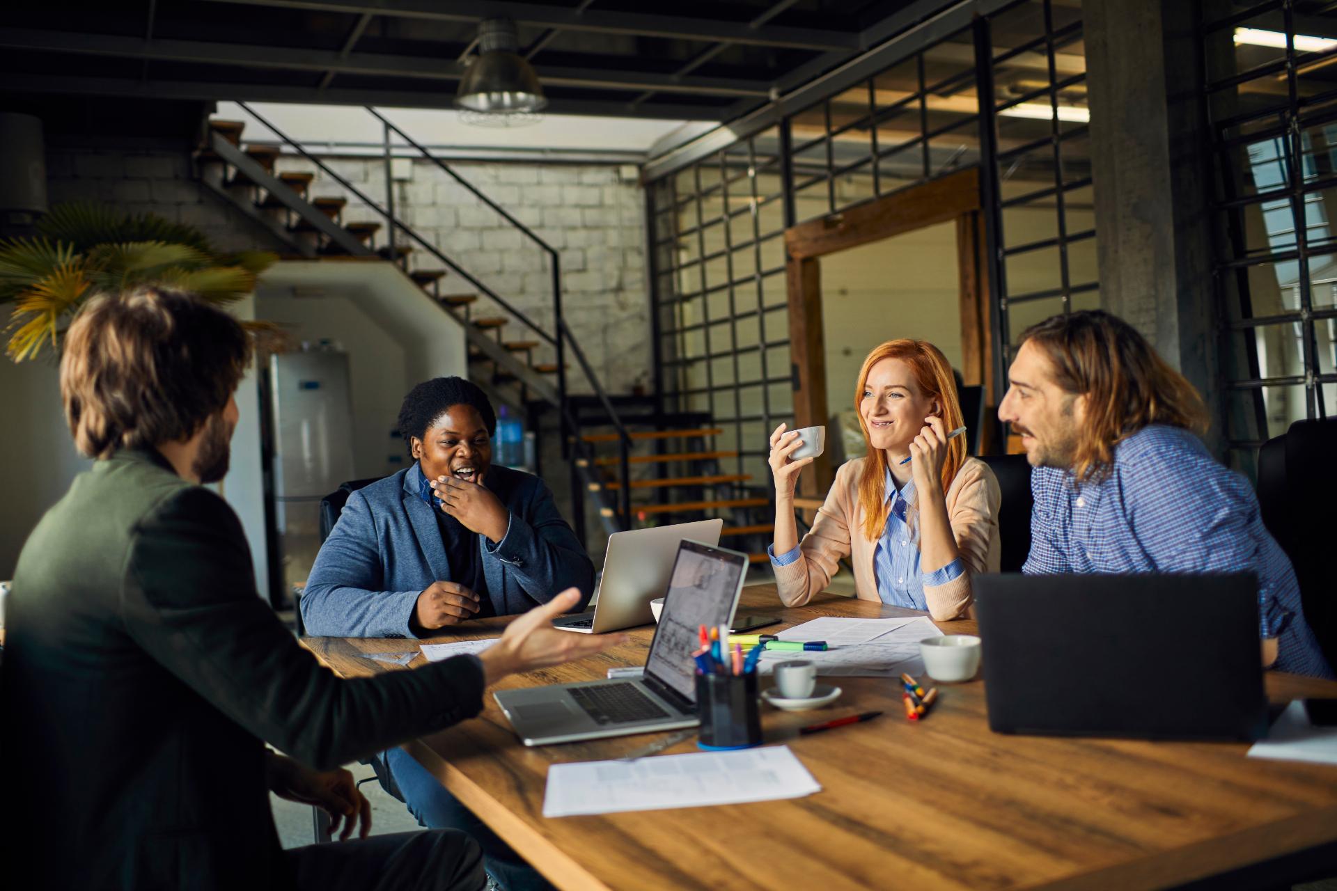 Young and diverse group of coworkers working on a project and having a meeting in a startup company office
