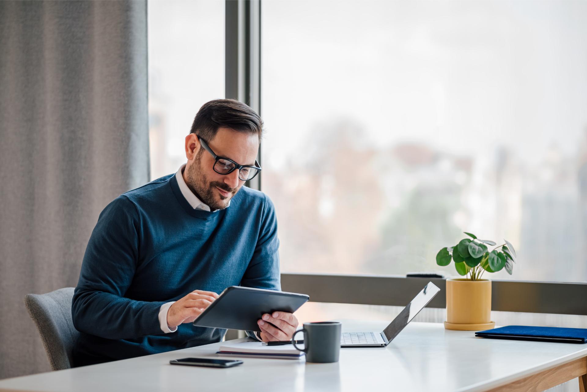 Young businessman using digital tablet while working in business office