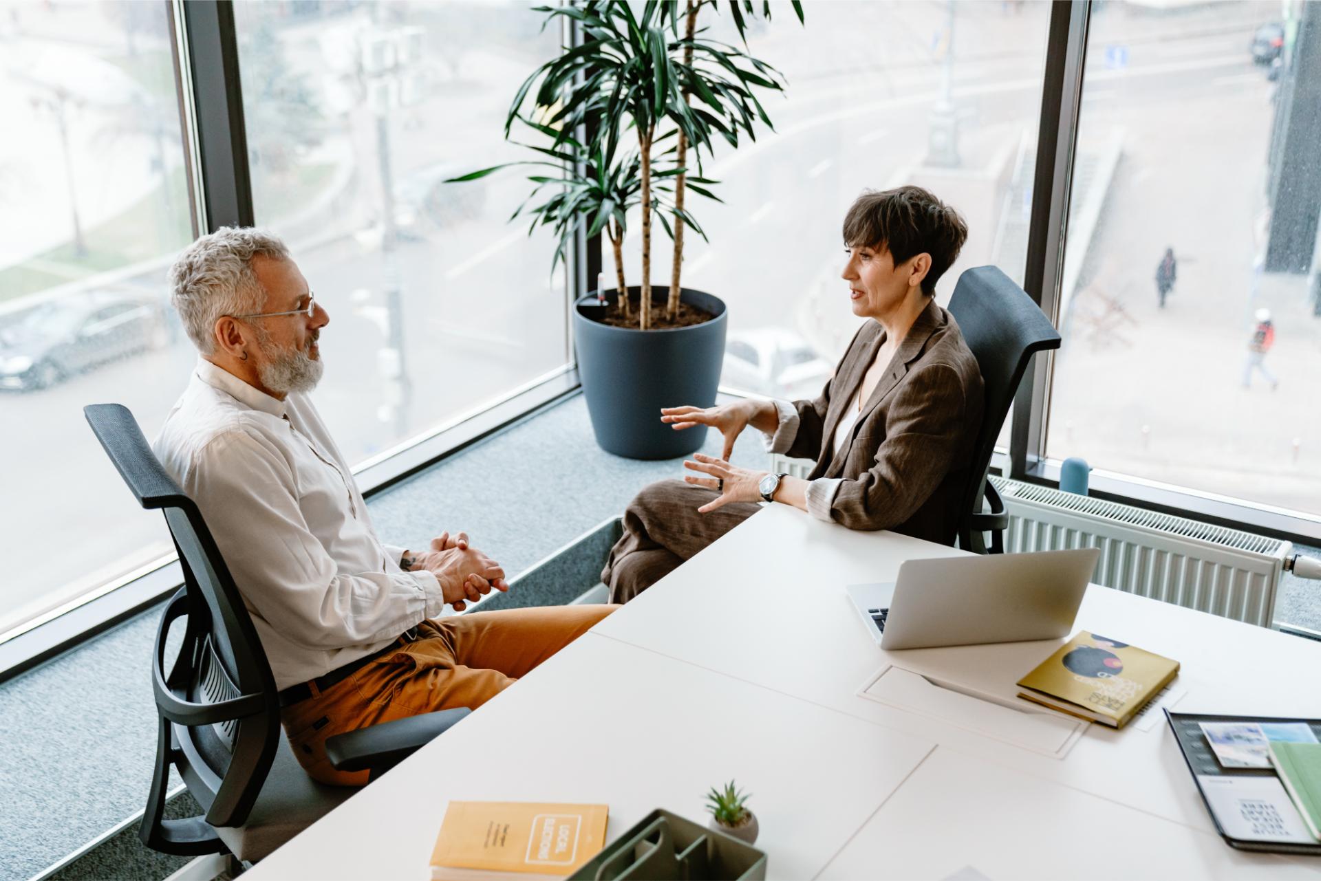 ortrait of professional man and woman sharing ideas during meeting in conference room