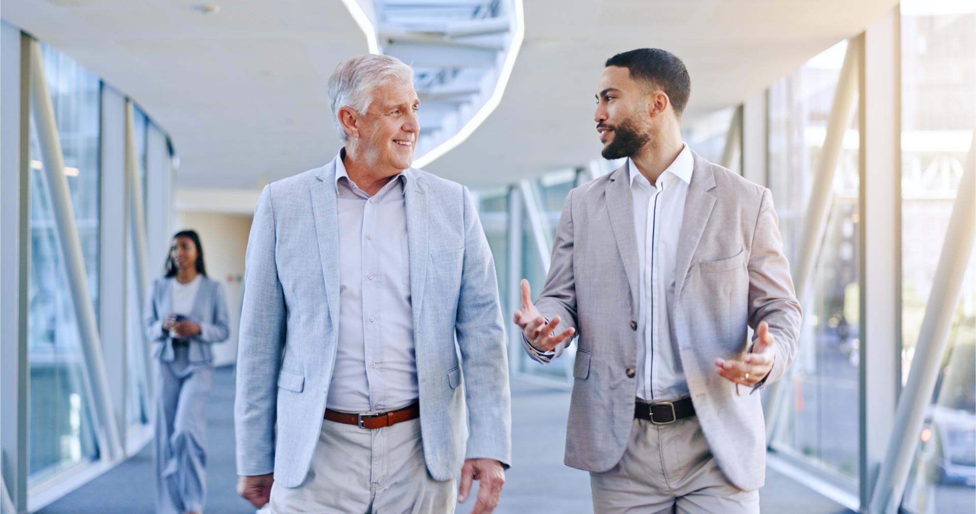 Tablet talking or business people walking in office together for networking or communication in digital agency