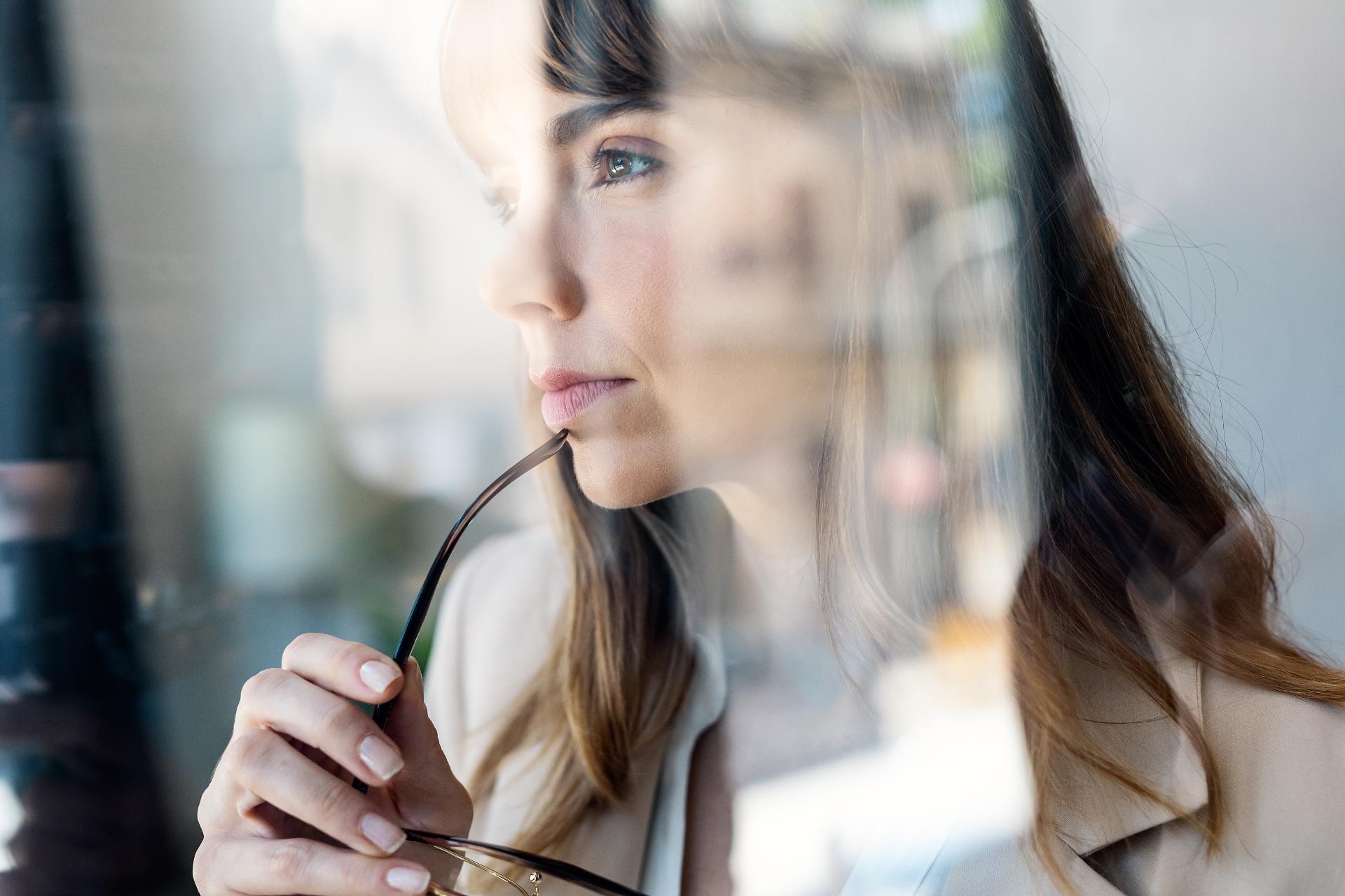 Confident young woman looking forwards while standing in the modern startup