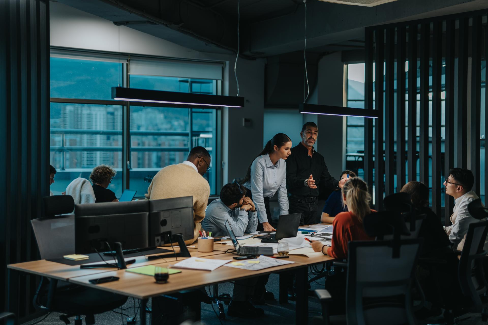 A diverse group of business people engage in a collaborative meeting in a contemporary office setting showcasing teamwork and innovative brainstorming to drive project success