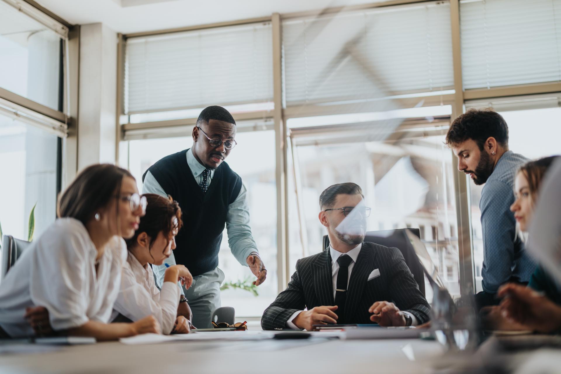 A diverse group of business people engaging in a collaborative meeting in a modern office setting