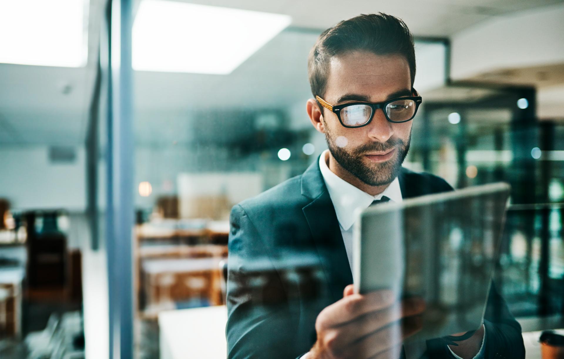 Reading tablet and businessman in office for research thinking and connectivity in workplace