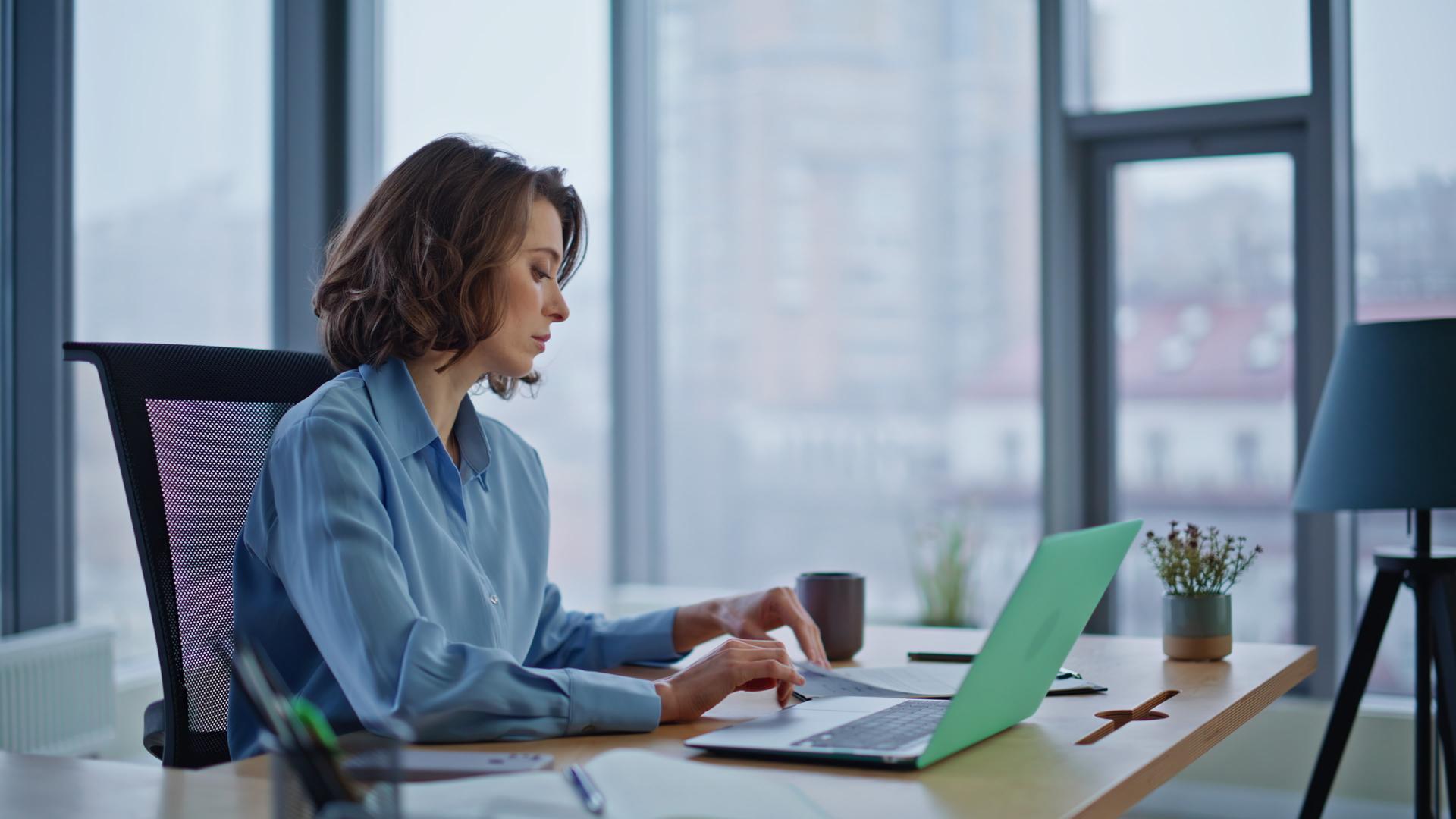 Businesswoman checking financial papers working office closeup