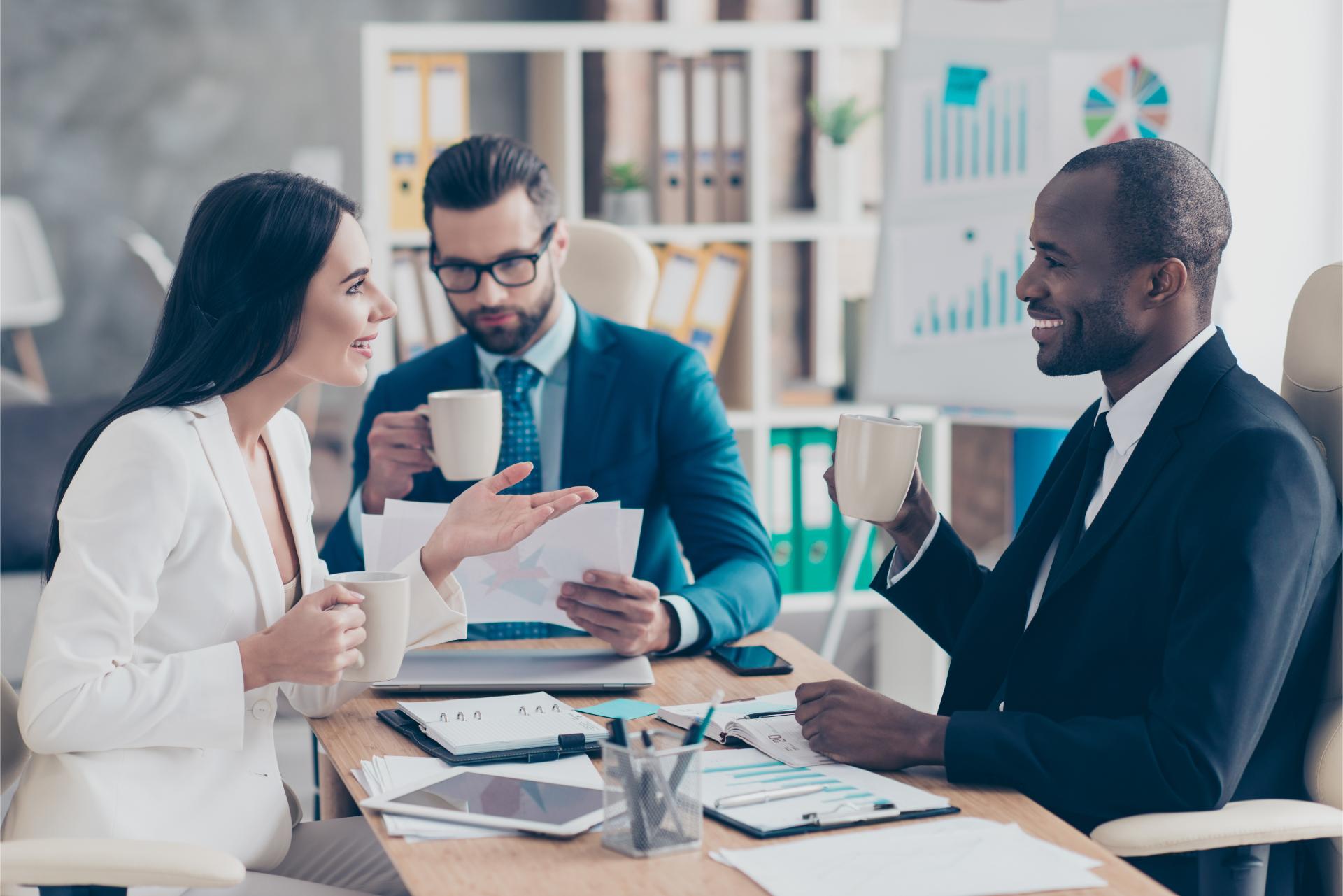 Three professional successful stylish elegant employees having break time during conference