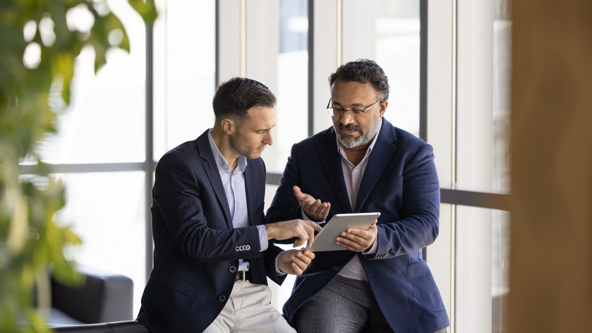 leaders discussing goal alignment strategy on tablet